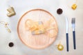 Christmas table setting. wooden plate and silverware on wooden background. Royalty Free Stock Photo