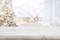 Christmas table top in front of blurred decorated window background Royalty Free Stock Photo