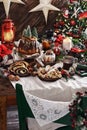 Christmas table with traditional pastries in rustic style interior Royalty Free Stock Photo