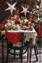 Christmas table with traditional pastries in rustic style interior Royalty Free Stock Photo