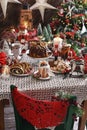 Christmas table with traditional pastries in rustic style interior Royalty Free Stock Photo