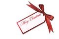 Christmas Tag Hanging From a Tied Red Holiday Bow Royalty Free Stock Photo