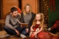 Christmas tales read by mommy and daddy to his little daughter