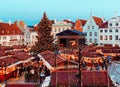 Christmas Tallinn Market place town hall square , tree decorated red balls and illumination on street in old town of Tallinn ,med