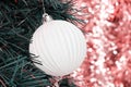 Christmas template with pink lights and evergreen tree branch with toy ball Royalty Free Stock Photo