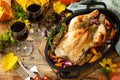 Christmas or Thanksgiving Homemade Roasted Turkey with Pumpkin and red wine in glasses on rustic background.