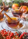 Mulled apple cider with spices: cinnamon sticks, cloves, anise on white table Royalty Free Stock Photo