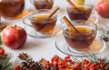 Side view of mulled apple cider with spices: cinnamon sticks, cloves, anise on white table Royalty Free Stock Photo