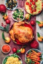 Christmas or Thanksgiving whole roasted chicken, rice, pumpkin, corn, honey, nuts, vegetable salads over wooden background. Top Royalty Free Stock Photo