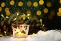 Christmas theme with candles, snow, pine cone and christmas light Royalty Free Stock Photo