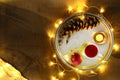 Christmas theme with candles, snow, pine cone and christmas light Royalty Free Stock Photo