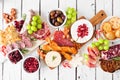 Christmas theme charcuterie table scene, top view against a white wood background