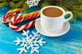 Christmas theme. A cup of coffee with milk cappuccino, in the form of bright candy canes and green spruce branches Royalty Free Stock Photo