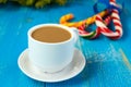 Christmas theme. A cup of coffee with milk cappuccino, in the form of bright candy canes and green spruce branches Royalty Free Stock Photo