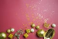 Christmas theme with golden ornaments and glitter over the red background. Royalty Free Stock Photo