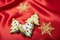 Christmas theme pine tree sugar coated cookies  on a bright red silk cloth Royalty Free Stock Photo