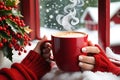 Christmas-Themed Coffee Cup Cradled Between Hands Adorned with a Cozy Red Knit Sweater - Steam Rising in the Festive Chill Royalty Free Stock Photo