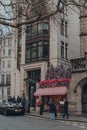 Christmas themed front of El and N cafe in Mayfair, London, UK, woman takes photo of it outside