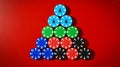 Christmas-themed stacked casino chips forming tree, solid red background Royalty Free Stock Photo