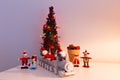 Christmas-themed table decoration with cute Santa and elf dolls riding a train, wooden figurines, planter