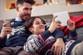 Christmas time- couple relaxing at home and using tablet Royalty Free Stock Photo