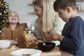 Christmas time spent on decorating gingerbread house Royalty Free Stock Photo