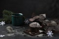 Christmas time. A festive evening with a warm drink and a chocolate muffin. green fir branches and snowflakes. Selective focus.