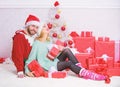Christmas is time for giving. Couple in love enjoy christmas holiday celebration. Family prepared christmas gifts