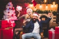 Christmas time for happy friends. Drunk Girls celebrate New Year. Woman and handsome man with Santa dress. Royalty Free Stock Photo