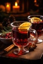 Christmas time, hot mulled wine in a glass, served rustically with lots of spices and lots of little lights on the table