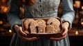 Christmas time: lady with an open Christmas package in her hands. Various Christmas gingerbread cookies.Horizontal banking