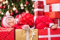 Christmas time, little baby child sleeping and holding gift Royalty Free Stock Photo