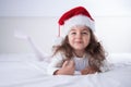 Happy Christmas time, little girl in Santa Claus hat smilling Royalty Free Stock Photo