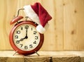 Christmas time - red alarm clock with santa hat Royalty Free Stock Photo