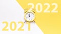 New year clock 2022. Retro style yellow clock in happy Christmas midnight. Countdown to happy xmas on yellow background Royalty Free Stock Photo