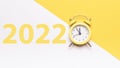 Christmas time 2022. Retro style yellow clock in happy Christmas midnight. Countdown to new year on happy xmas yellow Royalty Free Stock Photo