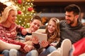 Christmas time- family watching funny video on digital tablet Royalty Free Stock Photo