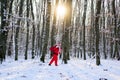 Christmas time with snow. Santa Claus walking to the winter forest with a bag of gifts. Happy New Year. Royalty Free Stock Photo