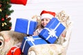 Christmas time and surprise concept. Adorable kid receives presents
