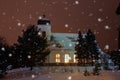 Christmas time, winter landscape, church in the evening in snowy weather, lit by lights