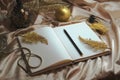 Christmas time, xmas decoration, happy new year 2020, golden notebook, bucket list, to do list and plans, candle on the table Royalty Free Stock Photo