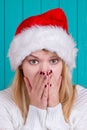 Christmas time. Young woman wearing santa claus hat red dress on blue background Royalty Free Stock Photo