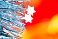 Christmas tinsel stars silver blue on red Royalty Free Stock Photo