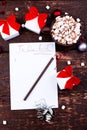 Christmas To Do List. Cup of hot cocoa or chocolate with marshmallow on wooden background. Flat lay. Christmas planning concept. Royalty Free Stock Photo