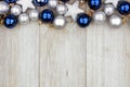 Christmas top border of blue and silver ornaments on gray wood Royalty Free Stock Photo