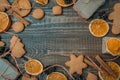 Christmas top view over a brown wooden background with gift boxes packed in a craft paper, cookies, dryed oranges, pine