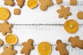 Christmas top view over a white wooden background with christmas cookies and dryed oranges. Flat lay, copy space, holiday banner.