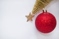 Christmas toy, brilliant red ball and golden Christmas tree. New Year. On a gray background Royalty Free Stock Photo