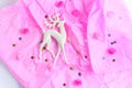 Christmas toy in the form of a deer on a pink background. golden star spangles. flat lay