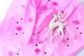 Christmas toy in the form of a deer on a pink background. golden star spangles. flat lay, top view
